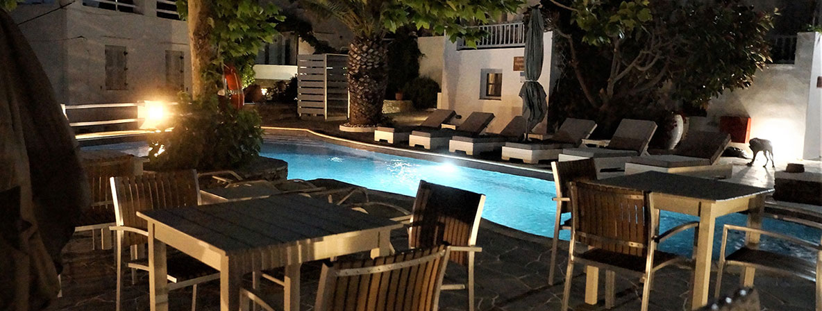 Pool and illuminated pool bar at night